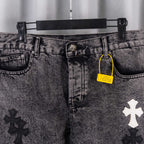 Denim pants waist with button, belt loops, and yellow hang tag near coin pocket.