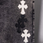 Denim fabric with stacked cross appliques in white and black on front panel.