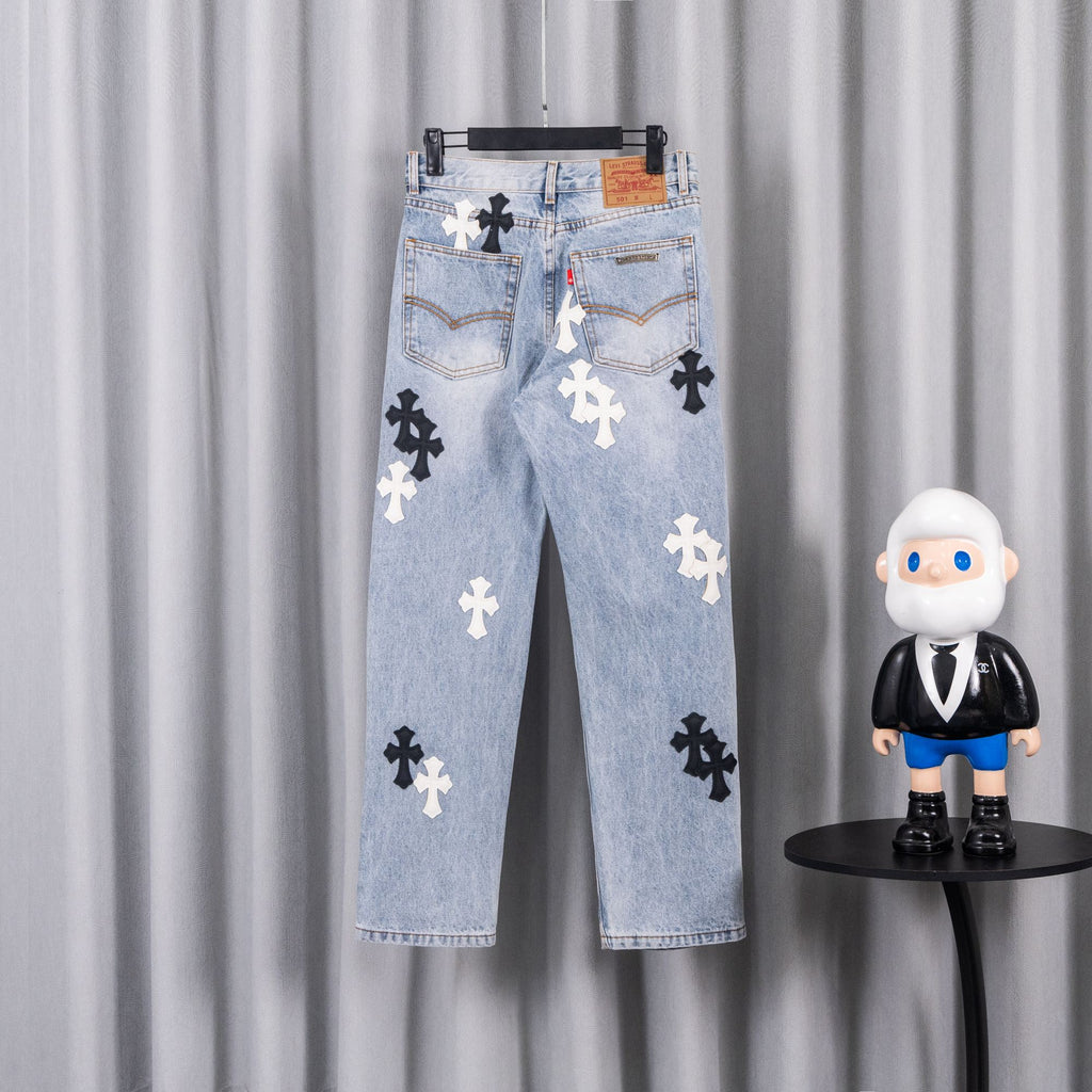 Light blue denim jeans with cross patches on back pockets.