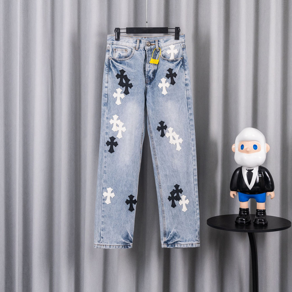Light blue denim jeans with black and white cross patches.