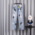 Light blue denim jeans with black and white cross patches.