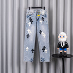 Light blue denim jeans with black and white cross patches.