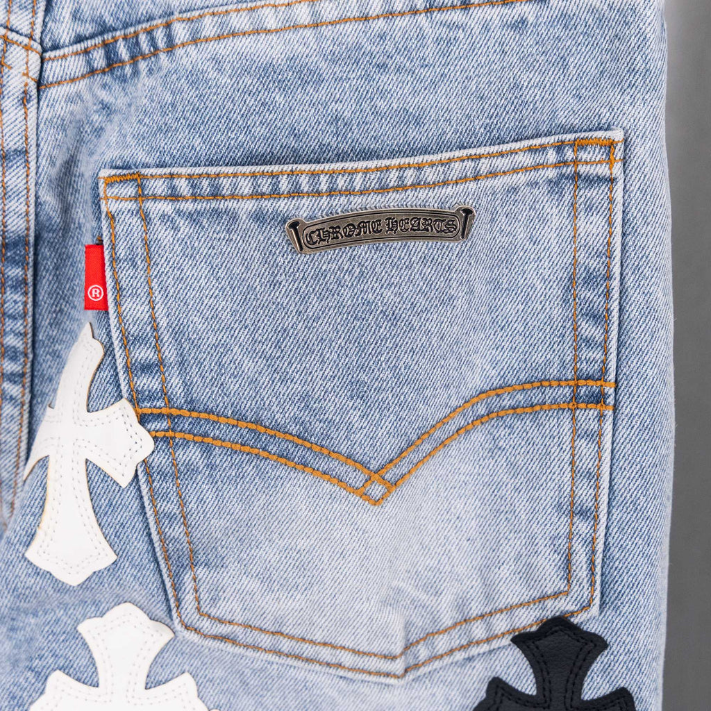 Light blue denim jeans close-up of back pocket logo patch.