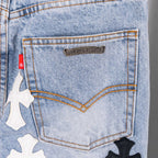 Light blue denim jeans close-up of back pocket logo patch.