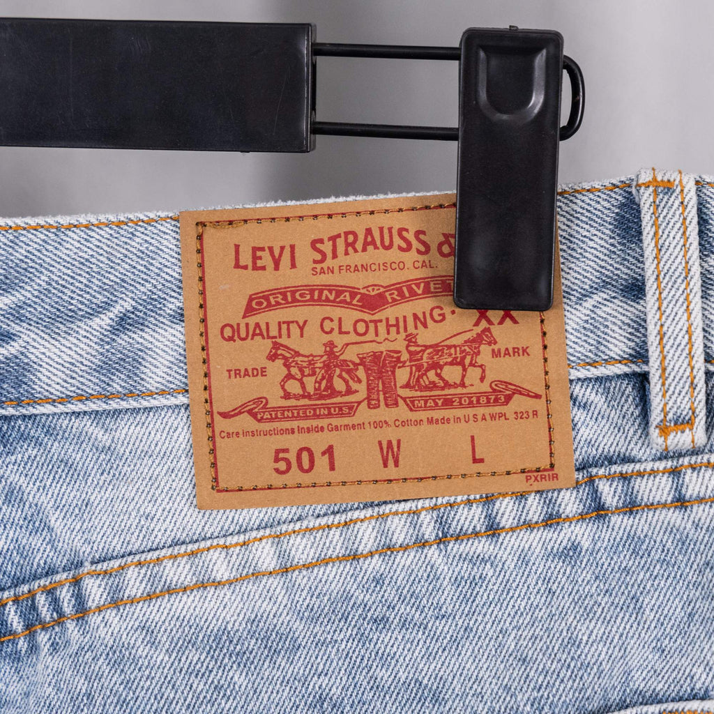 Light blue denim pants waistband with brand label patch reading 501 W L