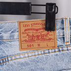 Light blue denim pants waistband with brand label patch reading 501 W L