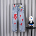 Light blue denim pants with red cross patches, straight leg, button fly
