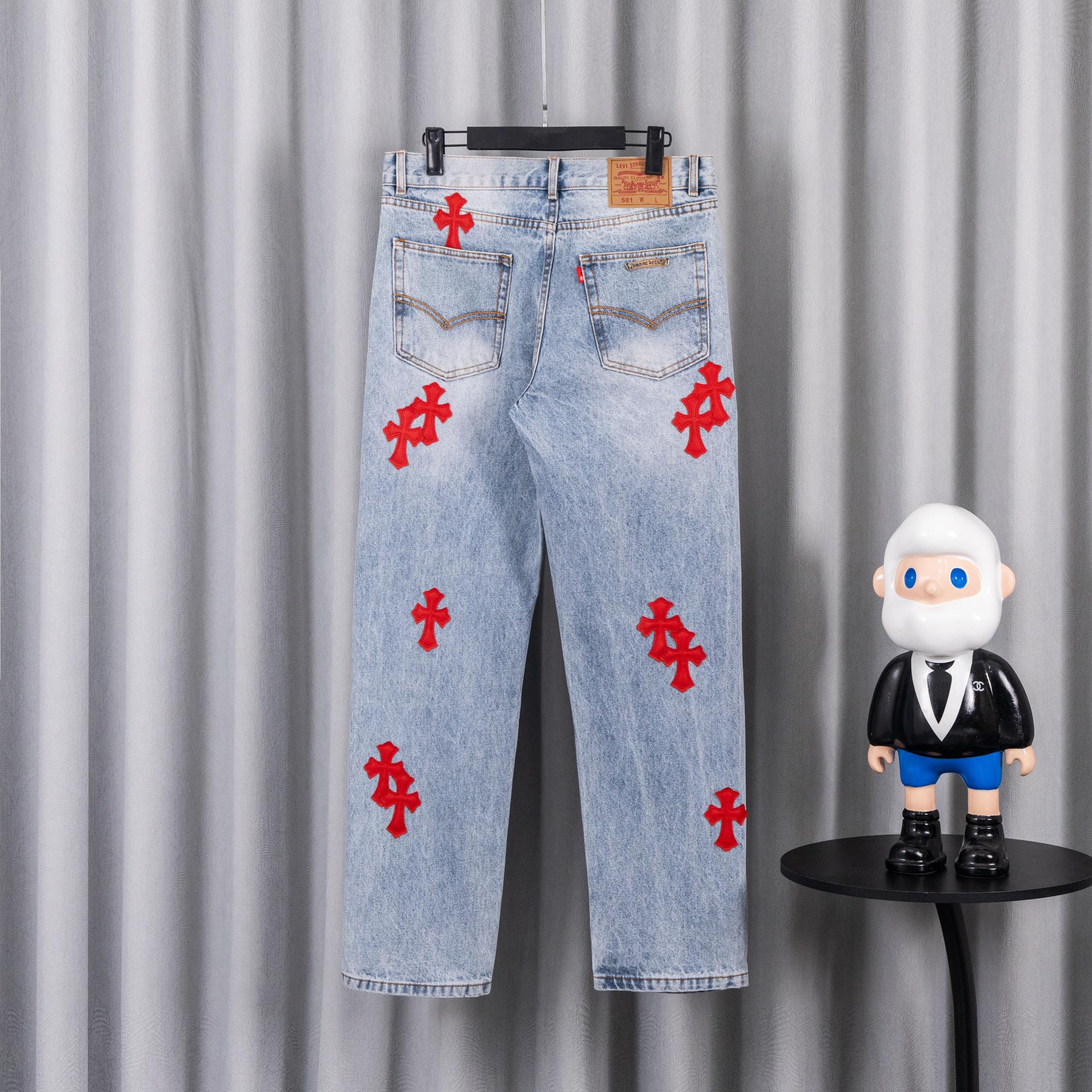 Light blue denim pants with red cross appliques on front, button fly