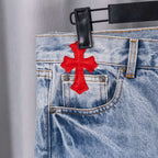 Chrome pants in light-blue denim with red cross embroidery on the front pocket
