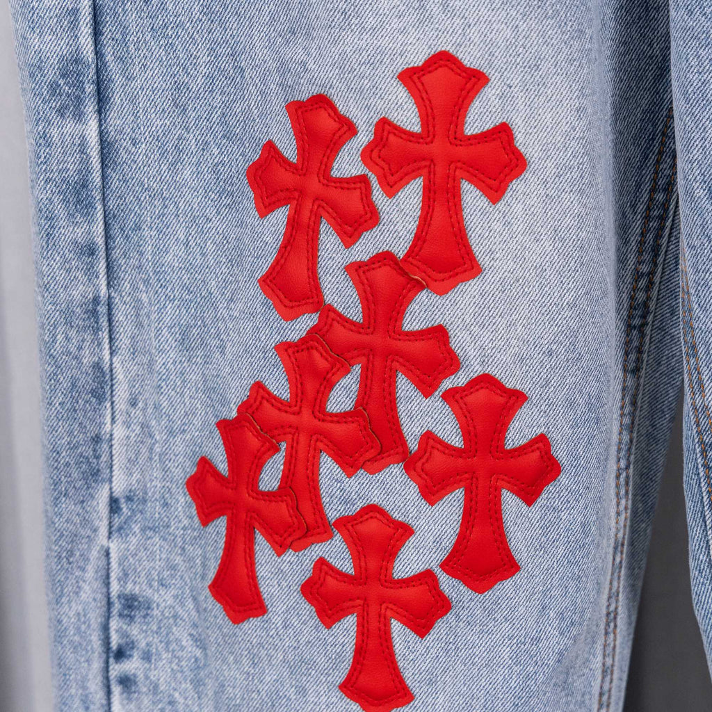 Chrome pants, light-blue denim with red cross embroidery on the leg