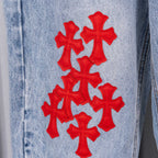 Chrome pants, light-blue denim with red cross embroidery on the leg