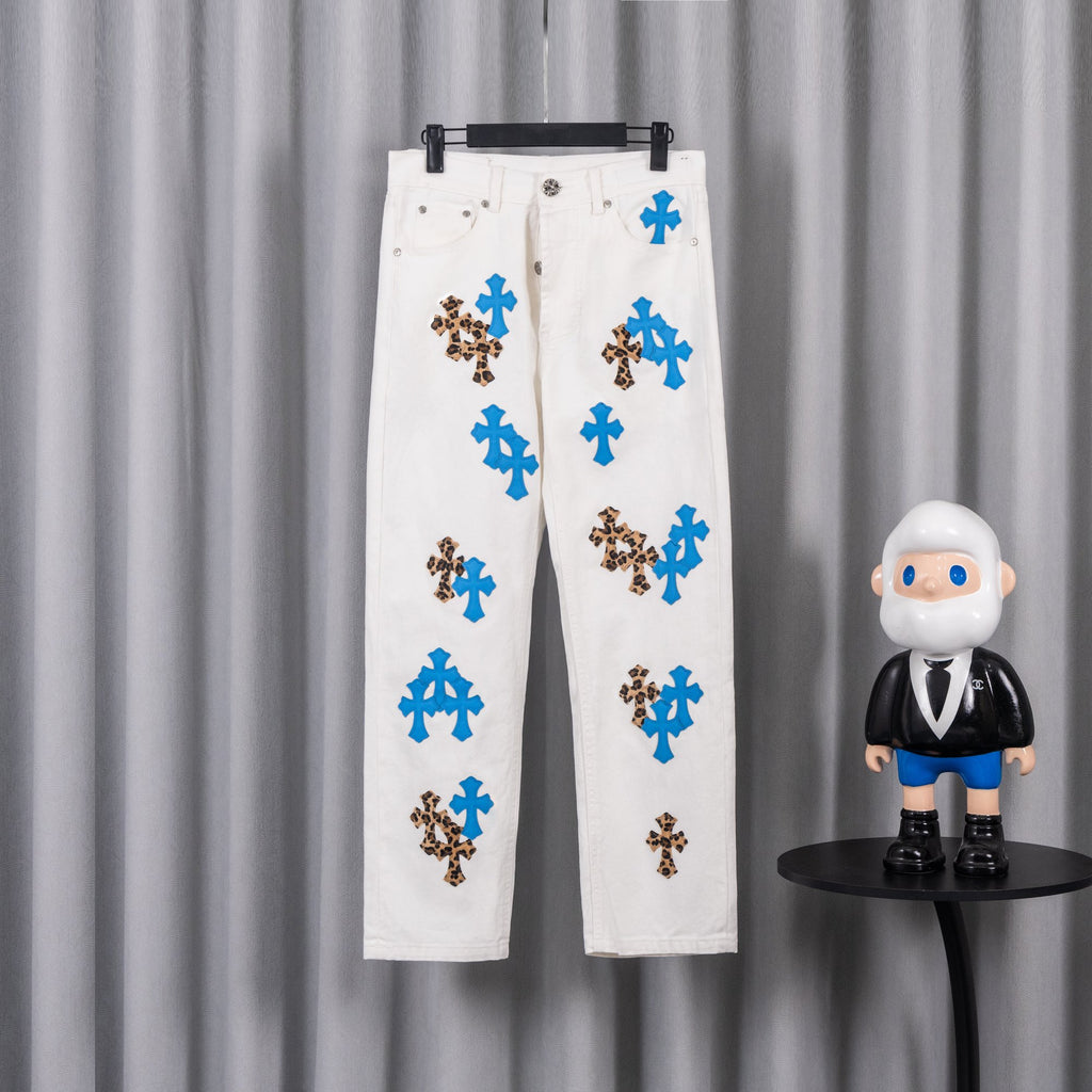 White pants with blue and leopard cross appliques, front view