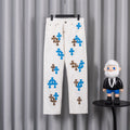 White pants with blue and leopard cross appliques, front view