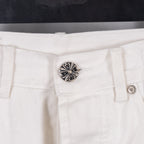 White pants with silver rivet button at waistband, centered close-up