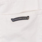 Pants metal logo bar on white denim near belt loop