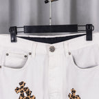 White denim pants waistband with silver button and leopard cross embroidery