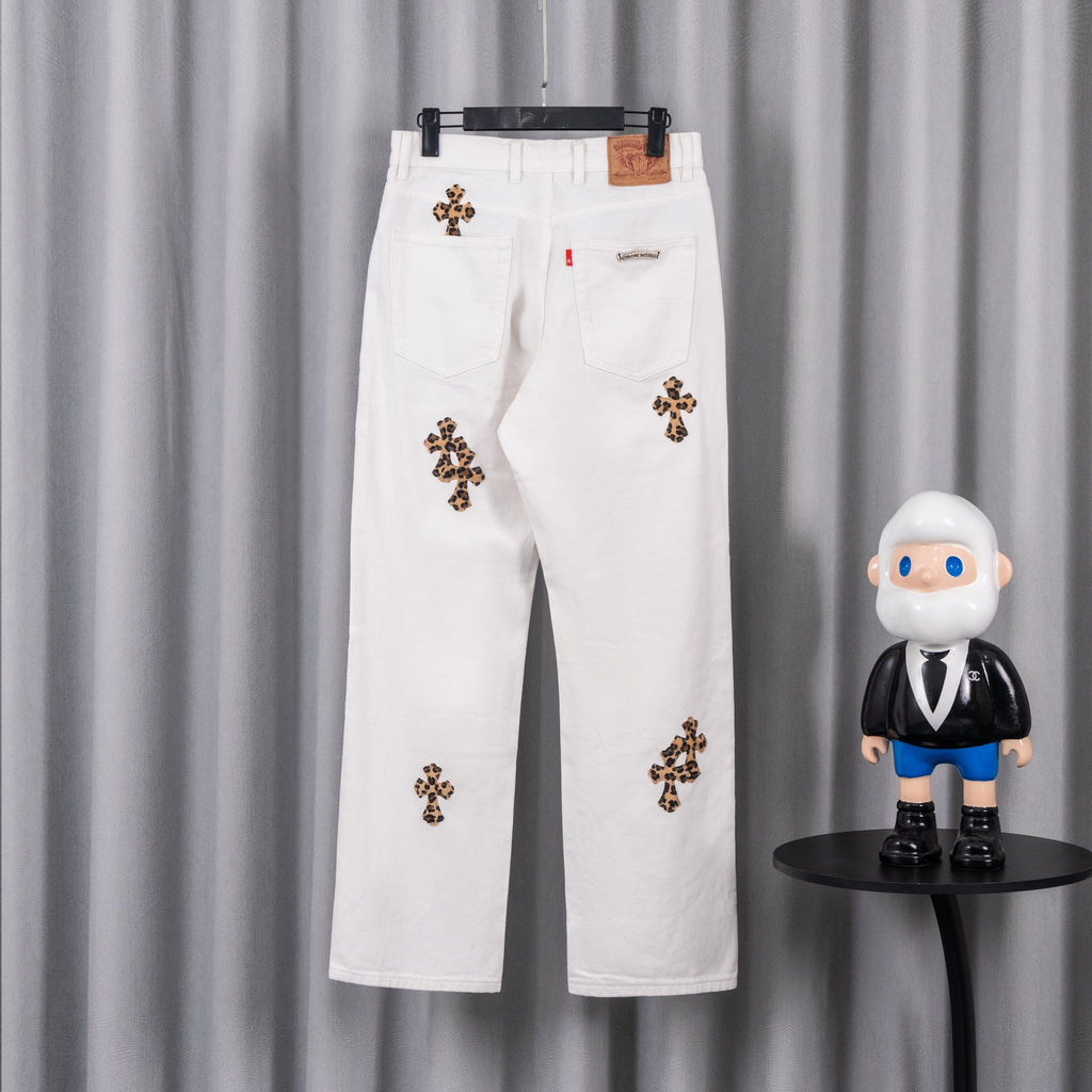 White denim pants with leopard cross patches and a small logo label