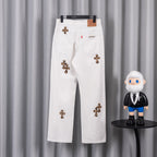 White denim pants with leopard cross patches and a small logo label