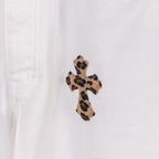 Leopard print embroidered cross patch on white denim