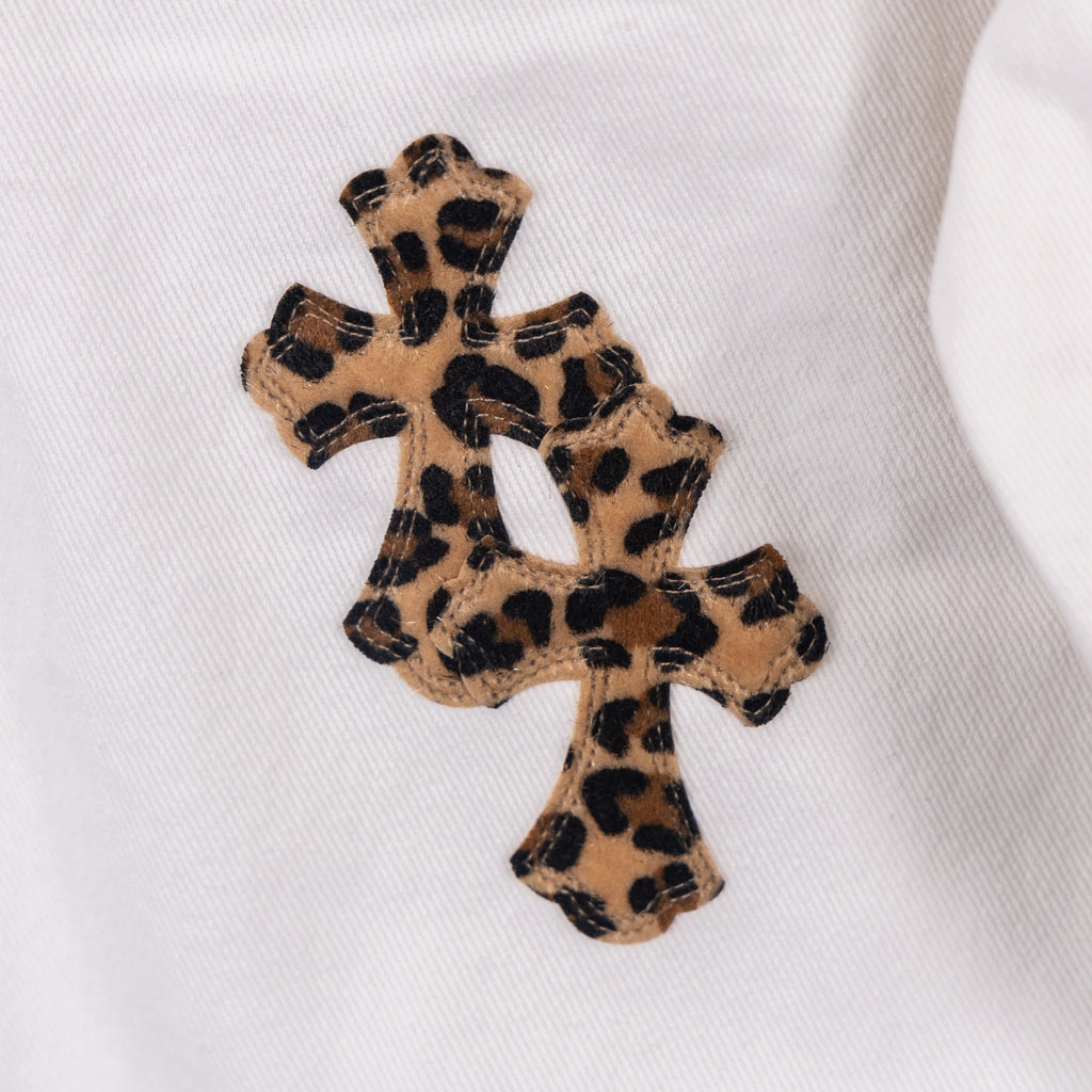 White pants with leopard print cross appliqué patch