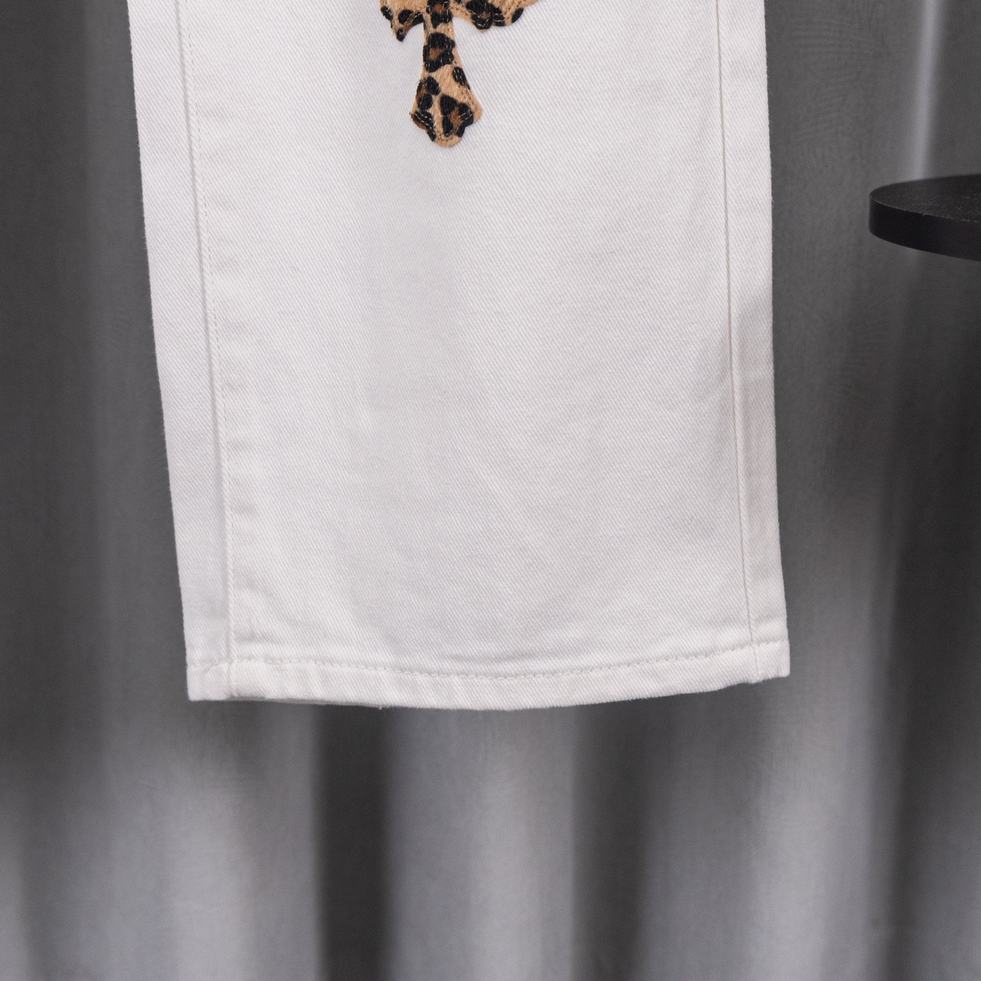White denim pants hem with stitched seam detail