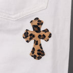 White pants with leopard cross appliqué on front