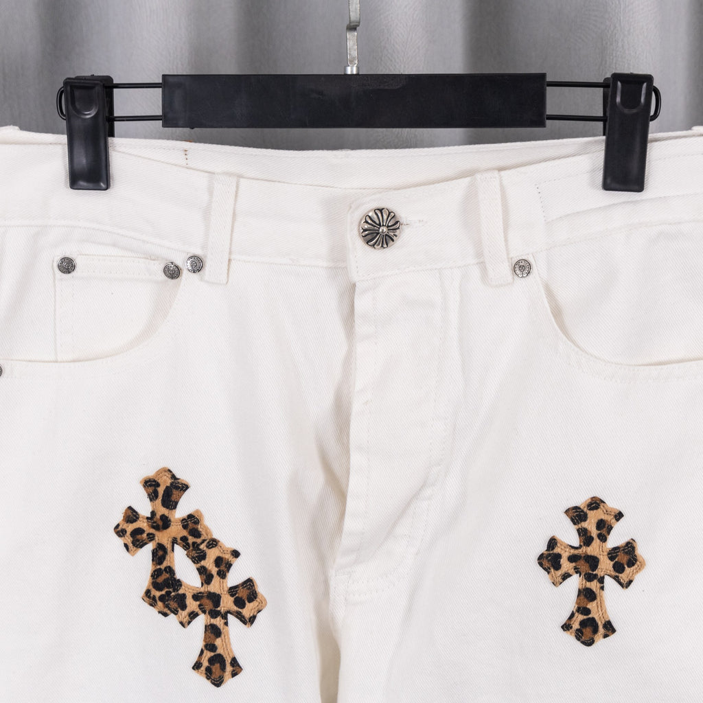 White denim pants with button waistband and leopard cross embroidery