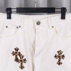 White denim pants with button waistband and leopard cross embroidery