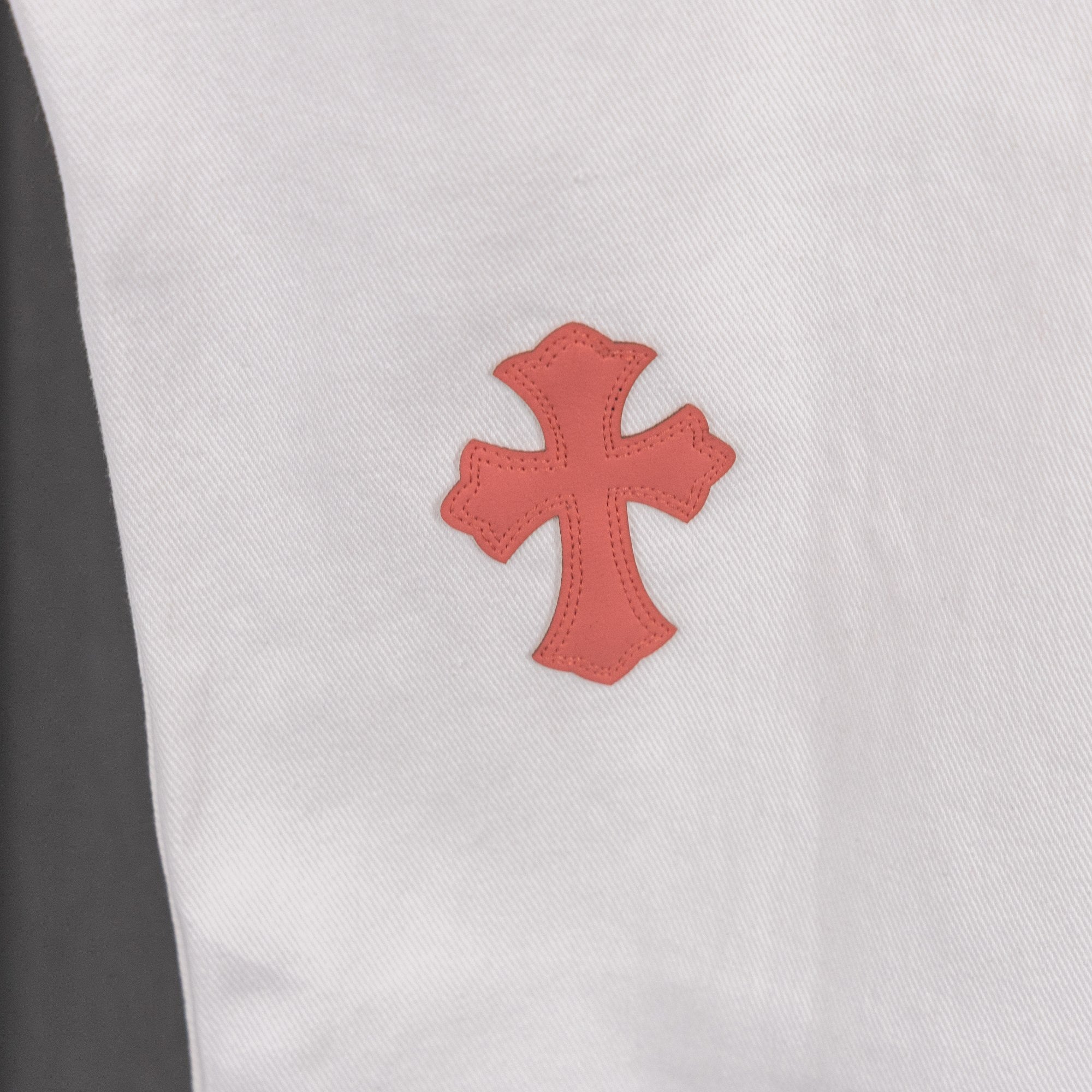 Red cross patch on white denim