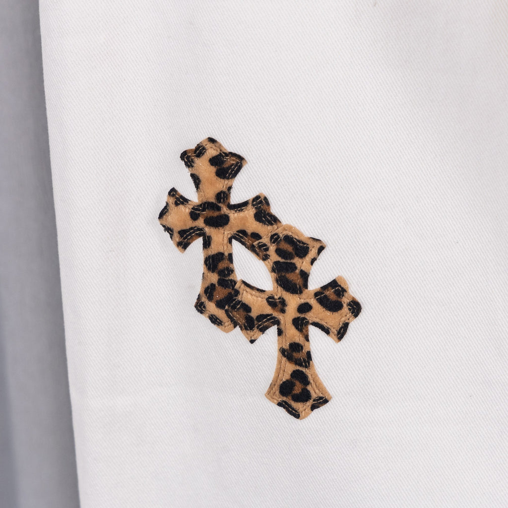 White denim pants with leopard print cross applique on leg