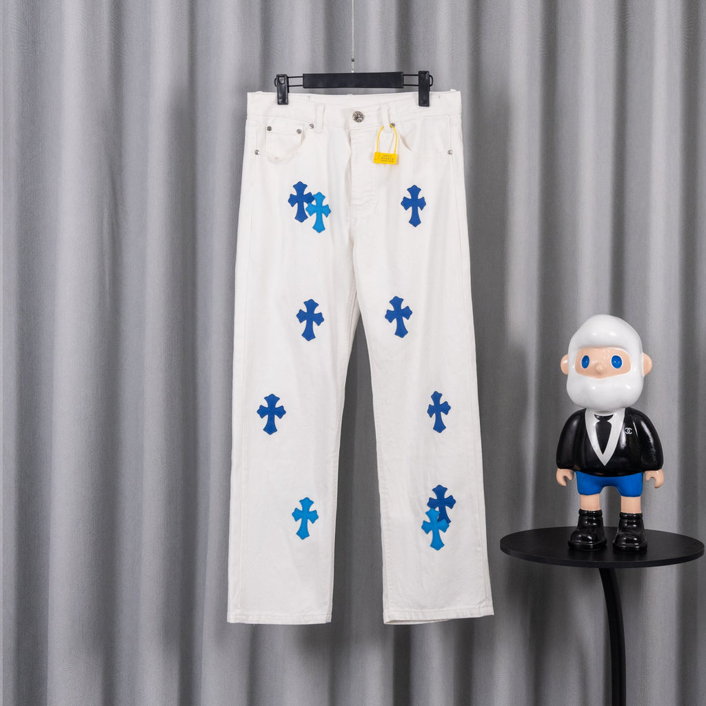 White denim pants with blue cross graphic print, front view on hanger
