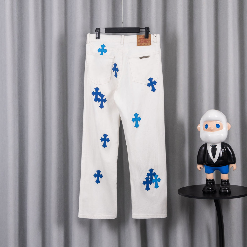 White denim pants with blue cross graphic print, back view on hanger