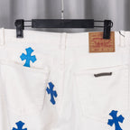 White denim pants with blue cross patch graphic, close-up of front pockets