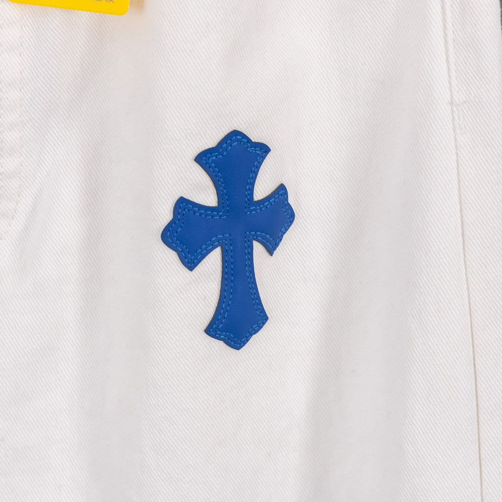 White denim pants with blue cross patch applique at hip