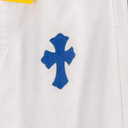 White denim pants with blue cross patch applique at hip