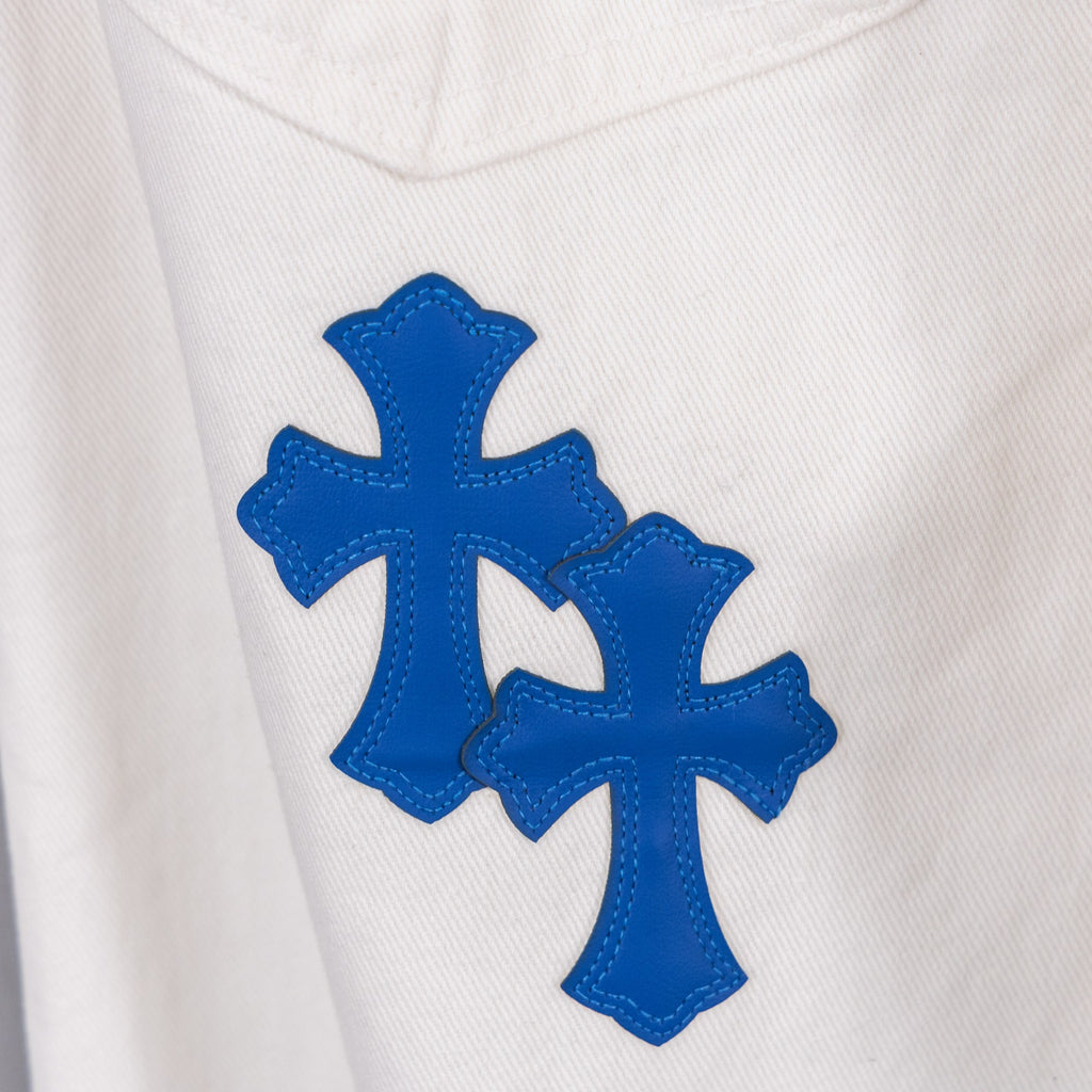 White denim pants with two blue cross patches on the thigh