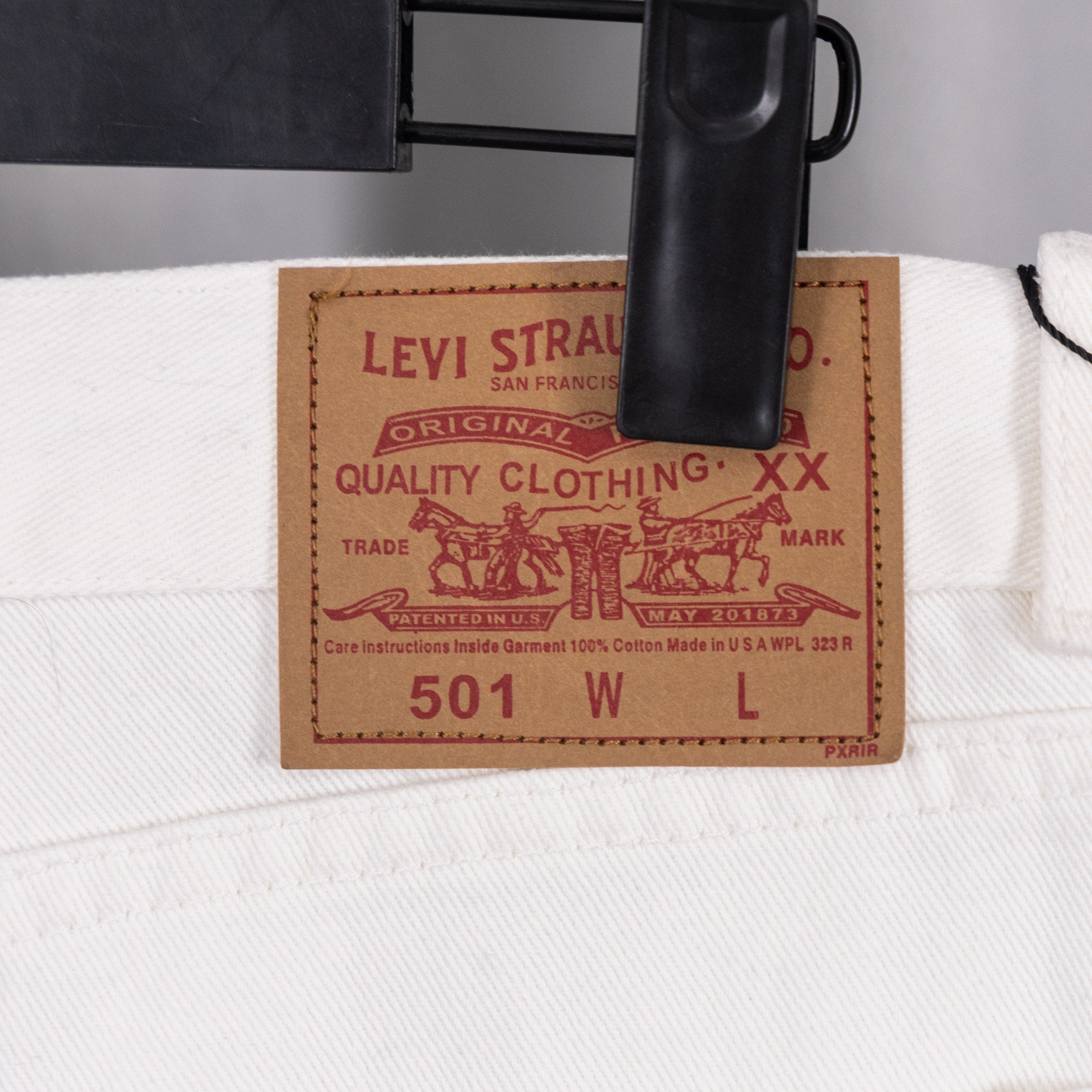 Levi Strauss 501 woven leather patch on white denim pants