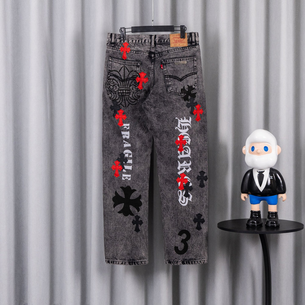 Dark gray denim jeans with red cross accents and black mirrored graphic on front