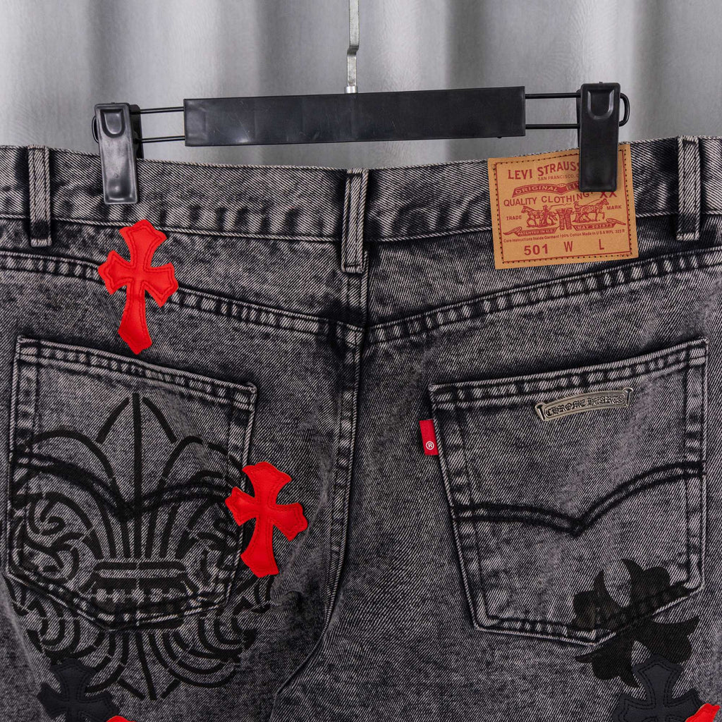Close-up of dark gray denim jeans waist with Levi Strauss label and pocket graphics