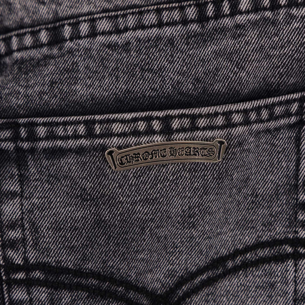 Dark gray denim jeans with small logo patch on front pocket