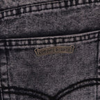 Dark gray denim jeans with small logo patch on front pocket