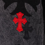 Black denim pants with red and black cross patch detail