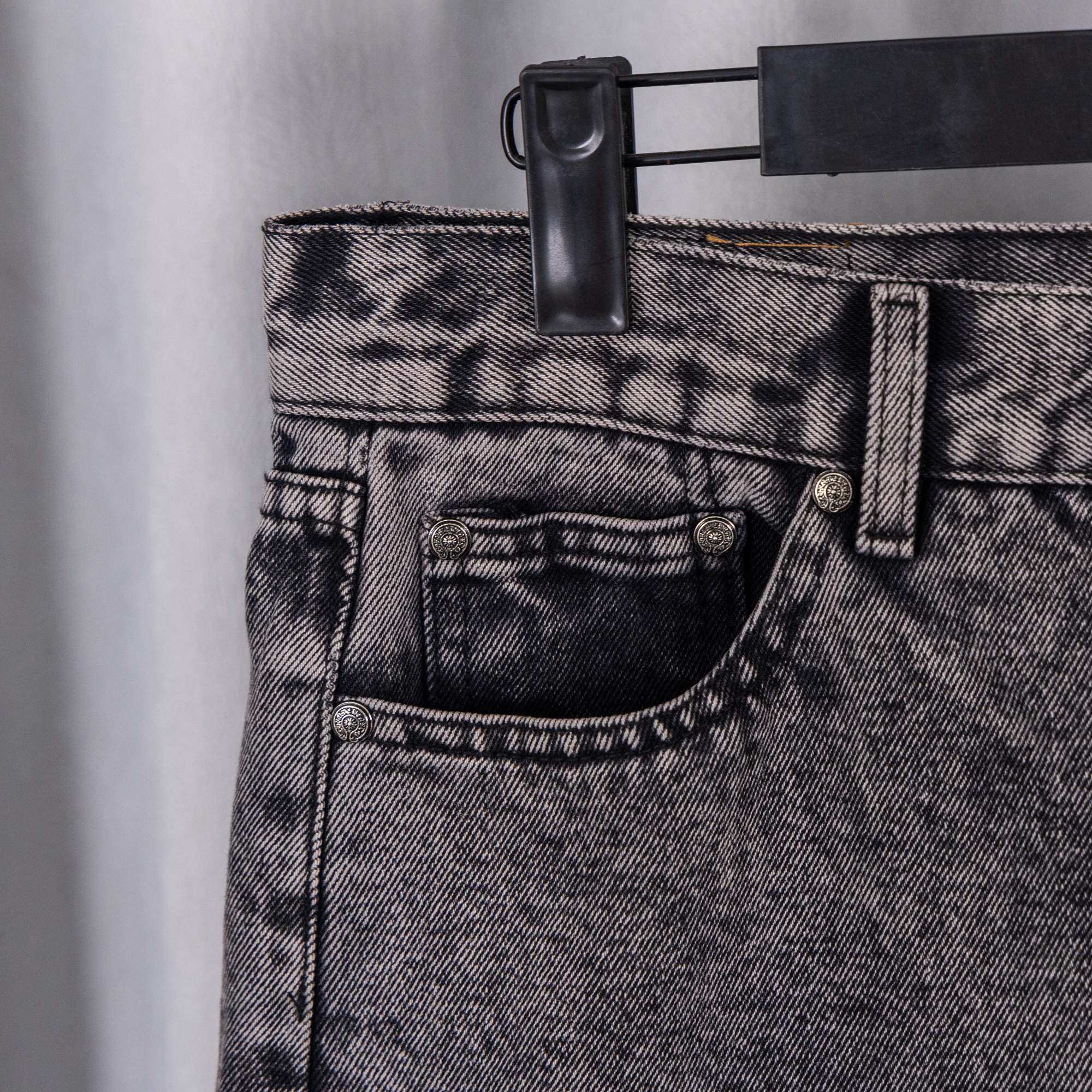 Black denim pants waistband with button fly and belt loops
