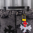 Black denim pants with belt loops, front pockets, and cross patches