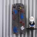 Dark gray denim pants with colorful graphic patches on legs