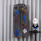 Dark gray denim pants with colorful graphic patches on legs