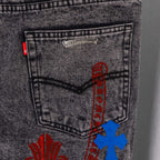 Dark denim pants pocket label with blue cross applique