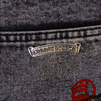 Logo rivet at waistband on dark denim with red emblem patch