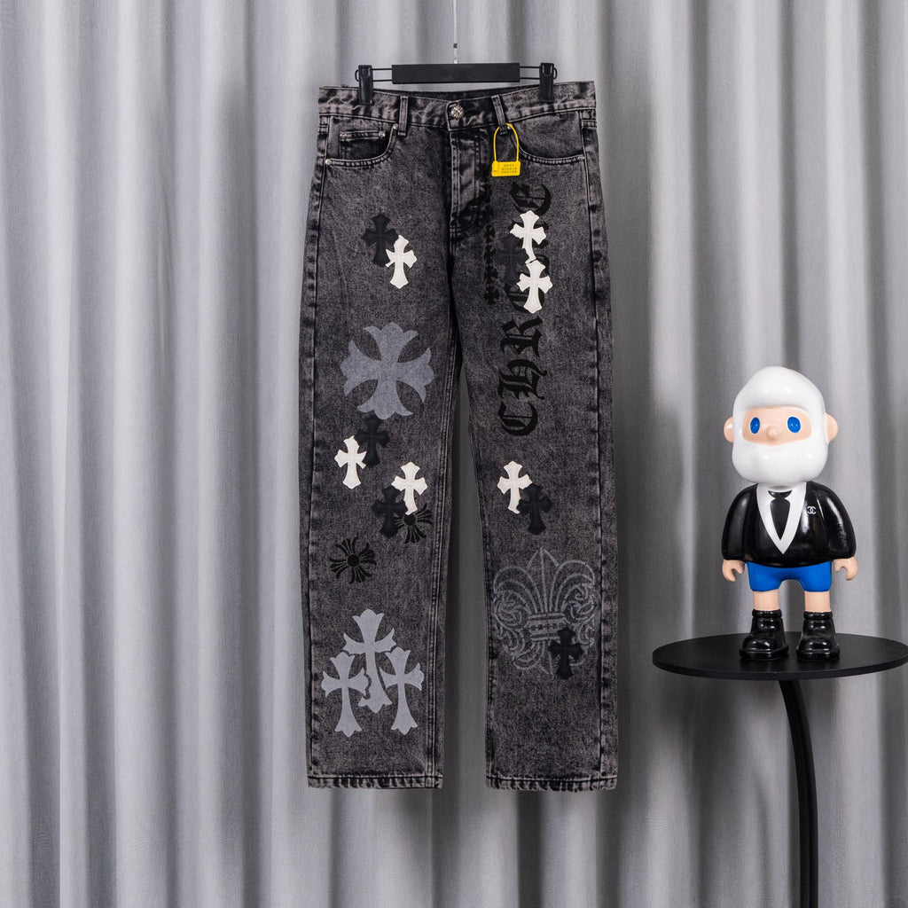Dark wash denim pants with cross-and-flower patches, front view