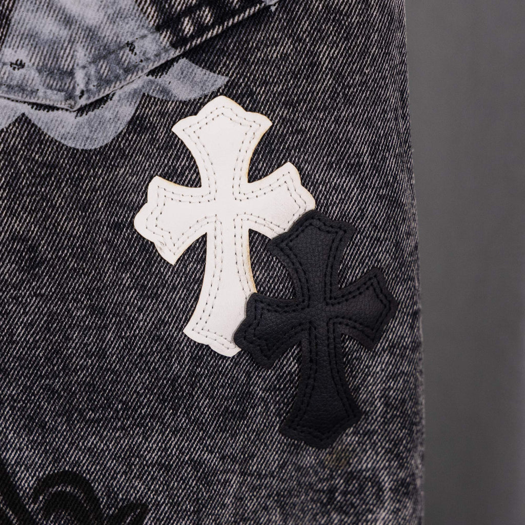 Denim close-up with white and black cross patches